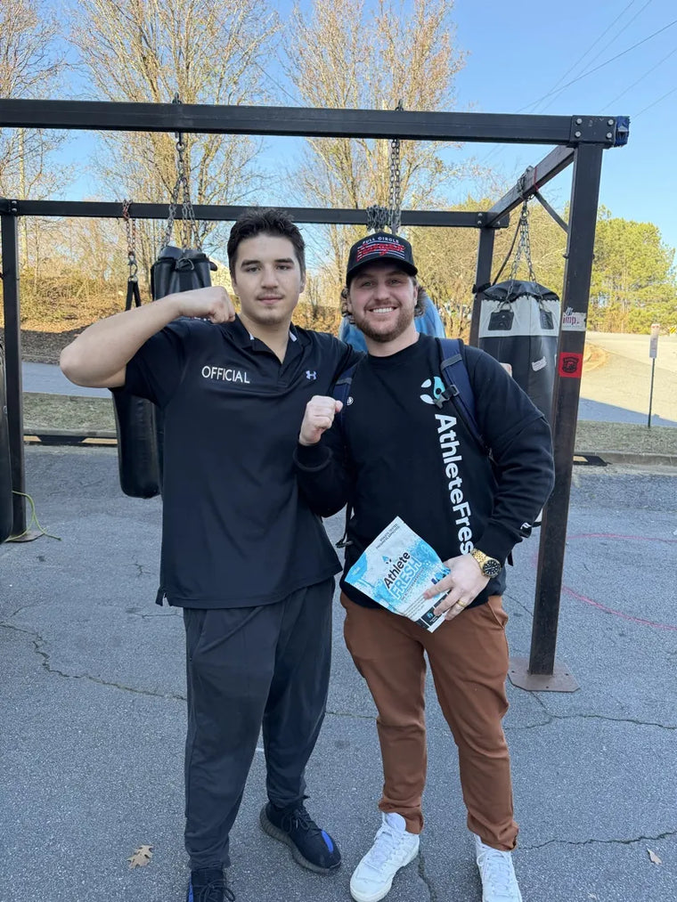 Two of the Athlete Fresh crew handing out product at a live event